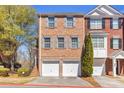 Charming townhome featuring a brick facade, double garage, and neat landscaping at 420 Heritage Park Nw Trce # 22, Kennesaw, GA 30144