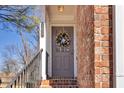Charming front entrance with a gray door, brick exterior, and elegant floral wreath at 420 Heritage Park Nw Trce # 22, Kennesaw, GA 30144