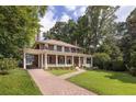 Beautiful brick home with a long driveway and manicured lawn surrounded by mature trees at 1308 Fairview Ne Rd, Atlanta, GA 30306