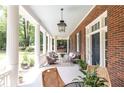 Inviting front porch with ample seating, decorative columns, and a hanging lantern at 1308 Fairview Ne Rd, Atlanta, GA 30306