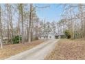 View of the home and long driveway surrounded by mature trees offering privacy and seclusion at 5001 Oakdale Dr, Douglasville, GA 30135