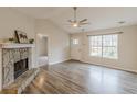 Bright living room with a stone fireplace, vaulted ceiling, and hardwood floors at 5001 Oakdale Dr, Douglasville, GA 30135