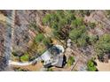 Gorgeous aerial view of a home nestled among the trees with circular driveway and beautiful landscaping at 1345 Bridgemill Ave, Canton, GA 30114