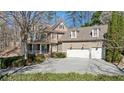 Stunning home with a three-car garage and well-manicured landscaping and inviting front porch at 1345 Bridgemill Ave, Canton, GA 30114