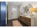 Stylish entryway features dark wood floors, modern light fixtures, and a decorative console table at 345 Glen Iris Ne Dr # 5, Atlanta, GA 30312