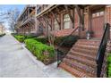 Charming brick townhome with a private entrance and manicured landscaping along a sidewalk at 345 Glen Iris Ne Dr # 5, Atlanta, GA 30312