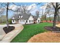 Stunning white home with an attached two car garage and circular driveway at 6110 Harvest Way, Cumming, GA 30028