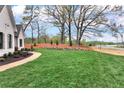 Expansive front yard with lush green grass and a curving walkway leading to the entrance at 6110 Harvest Way, Cumming, GA 30028