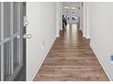 View of the hallway with wood floors, leading to a bright living area, creating a welcoming ambiance at 311 Ivy Chase Loop, Dallas, GA 30157