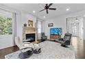 Bright living room with hardwood floors, a stone fireplace, and three leather chairs at 5930 Brundage Ln, Norcross, GA 30071