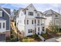 Side view of a stylish home with white siding, showcasing its well-manicured yard at 5930 Brundage Ln, Norcross, GA 30071