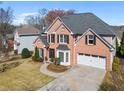 Well-maintained brick home with a two-car garage, manicured lawn, and tasteful landscaping at 1264 Ridge Vista Nw Ct, Lawrenceville, GA 30043