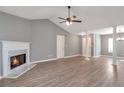 Living room featuring fireplace, hard floors, vaulted ceiling and large columns at 1321 Stoneleigh Dr, Conyers, GA 30094