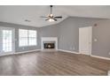 Spacious living room with a fireplace, modern floors, and ample natural light at 1321 Stoneleigh Dr, Conyers, GA 30094