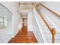 Inviting foyer with hardwood floors, staircase, and white trim, leading to carpeted living spaces and arched doorways at 2848 Stockbridge Way, Dacula, GA 30019