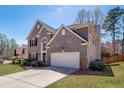 Beautiful brick home featuring a two-car garage and landscaped front yard at 2848 Stockbridge Way, Dacula, GA 30019