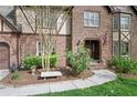 Beautiful brick home showcasing manicured landscaping, a stone bench, and a welcoming front entrance at 2702 Long Lake Ne Ter, Roswell, GA 30075