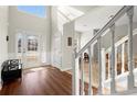 Bright, airy foyer with lots of natural light, hardwood floors, and a beautiful staircase at 5040 Mundy Ct, Cumming, GA 30028