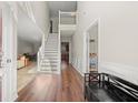 Bright foyer with soaring ceilings, hardwood floors, and staircase leading to the second floor at 5040 Mundy Ct, Cumming, GA 30028