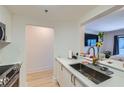 Bright kitchen featuring stainless appliances, stone countertops, and breakfast bar with plants at 1280 W Peachtree Nw St # 2601, Atlanta, GA 30309