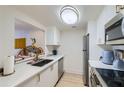 Modern kitchen featuring white cabinets, stainless steel appliances, and stylish quartz countertops at 1280 W Peachtree Nw St # 2601, Atlanta, GA 30309
