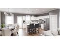 Spacious kitchen with stainless steel appliances, white cabinets, an island, and an adjacent dining area at 40 Alameda St # 131, Loganville, GA 30052