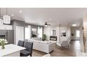 Open-concept living room with fireplace, stairs, access to the kitchen, and great light at 40 Alameda St # 131, Loganville, GA 30052