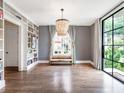Bright living room with hardwood floors, built-in shelves, and a decorative chandelier at 405 9Th Ne St, Atlanta, GA 30309