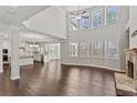 Spacious living room boasting a stone fireplace, high ceilings, and large windows for natural light at 6040 Ashborough Park, Cumming, GA 30040