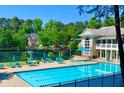 Community pool and tennis courts surrounded by lush landscaping and mature trees at 12350 Broadleaf Ln, Johns Creek, GA 30005