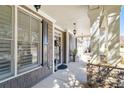 Charming front porch with stone accents, neutral colors, elegant light fixtures, and welcoming entry at 4183 Hill House Sw Rd, Smyrna, GA 30082