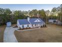 Aerial view of home showing long driveway and lush surrounding greenery at 5761 Dixie Hwy, Rutledge, GA 30663
