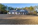 Charming single-story home featuring a welcoming front porch and lush lawn at 5761 Dixie Hwy, Rutledge, GA 30663
