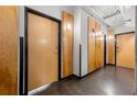 Hallway with wooden doors, concrete floors and exposed industrial ceiling at 120 Ralph Mcgill Ne Blvd # 312, Atlanta, GA 30308