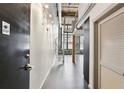 Hallway featuring a spiral staircase and industrial-style design with exposed pipes and brick accents at 170 Boulevard Se # 127E, Atlanta, GA 30312