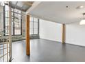 Bright living room with large windows, exposed brick walls, and modern gray flooring at 170 Boulevard Se # 127E, Atlanta, GA 30312