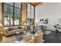 Spacious living room with exposed brick, large windows, and stylish furniture with contemporary decor at 170 Boulevard Se # E127, Atlanta, GA 30312