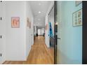 Bright hallway featuring hardwood floors, modern art, and glass-paneled doors at 1926 Trotti Ne St, Atlanta, GA 30317