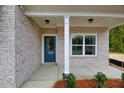 Inviting front porch with stylish blue door, brick facade, and well-lit entrance at 2955 Jefferson St, Austell, GA 30106