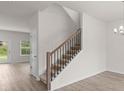 Bright interior shot featuring a staircase with wood railing and neutral-toned carpet at 2955 Jefferson St, Austell, GA 30106