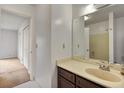 Bathroom with a wooden vanity, cream countertops, and large mirror, creating a calm atmosphere at 6 Nw Fairway Nw Dr, Kennesaw, GA 30144
