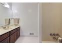 Bathroom with a wooden vanity, cream countertops, and large mirror, creating a calm atmosphere at 6 Nw Fairway Nw Dr, Kennesaw, GA 30144