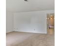 Spacious living room with neutral carpeting and a view into the next room at 6 Nw Fairway Nw Dr, Kennesaw, GA 30144