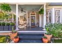 Inviting front porch with a ceiling fan, tasteful decorations, and ample space for relaxing and enjoying the outdoors at 1069 Colquitt Ne Ave, Atlanta, GA 30307