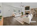 Bright living room featuring a stone fireplace, vaulted ceiling, and neutral decor at 68 Silverthorne Pass, Douglasville, GA 30134