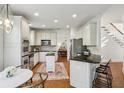 Spacious kitchen featuring stainless steel appliances, white cabinetry, and a center island with barstool seating at 4164 Gateswalk Se Dr, Smyrna, GA 30080