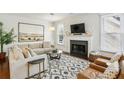 Bright living room features a fireplace, neutral-toned furnishings, and a decorative rug at 4164 Gateswalk Se Dr, Smyrna, GA 30080