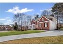 Beautiful brick home with a well-manicured lawn and a long driveway leading to a charming garage at 4140 Hillsborough, Cumming, GA 30041