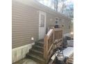 Side entrance to a home with wooden steps and a simple back door at 53 Oakview Dr, Carrollton, GA 30116