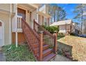 Covered front porch with railing leads to the front door of this beautiful home at 539 Villa Rosa Rd, Temple, GA 30179